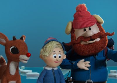 Rudolph Video Still of Rudolph, elf, and mountain man.